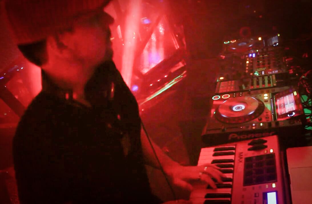 Club set in red light at the keys and decks, 2014