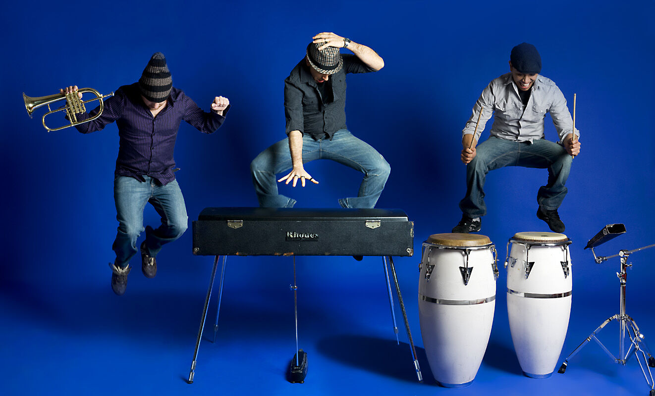 2009: the band press shoot, mid-air on the blue set